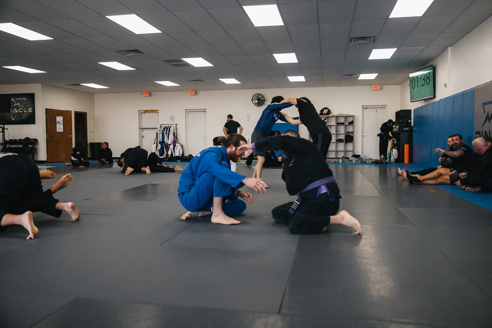 The adult gi class drilling together on the mats at Pinnacle in North Phoenix