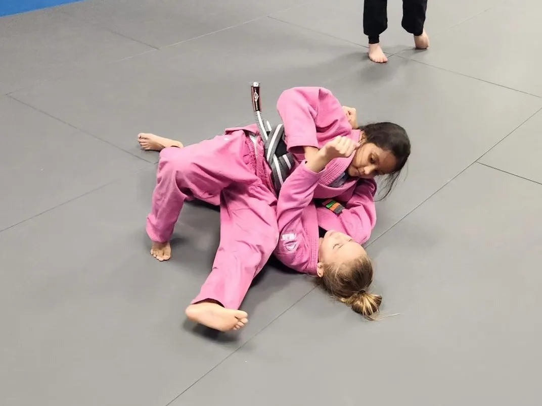 Two young students drilling from guard during a kids class at Pinnacle Brazilian Jiu Jitsu